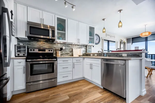 a kitchen with stainless steel appliances granite countertop a stove and a microwave