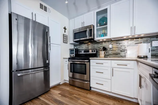 a kitchen with stainless steel appliances a refrigerator stove and sink