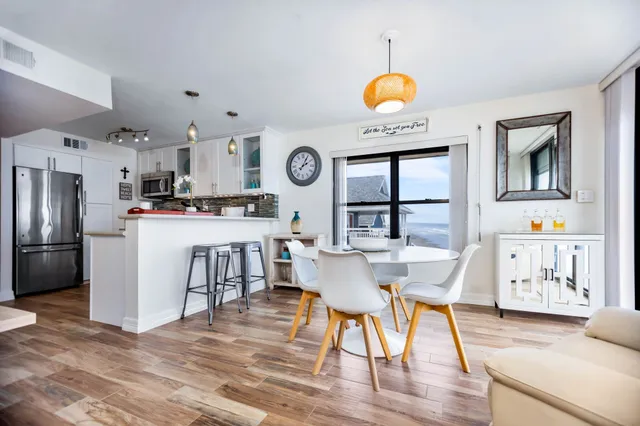 a living room with furniture a flat screen tv and a table