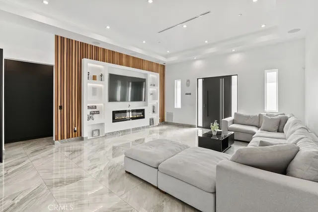 a kitchen with stainless steel appliances kitchen island granite countertop a refrigerator and a stove top oven