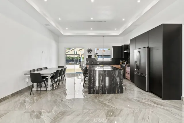 a kitchen with granite countertop a stove and a shower