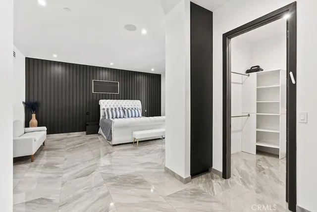 a bedroom with a bed and a chair