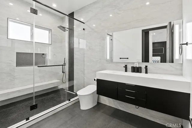 a bed sitting in a spacious bedroom next to a window