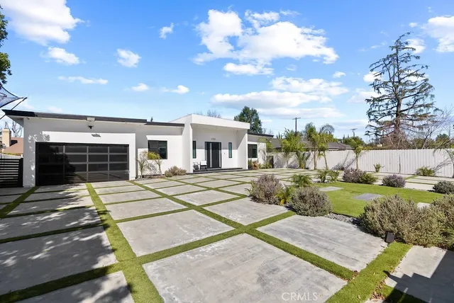 a living room with furniture and view of kitchen