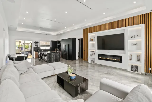 a kitchen with stainless steel appliances kitchen island granite countertop a table and chairs