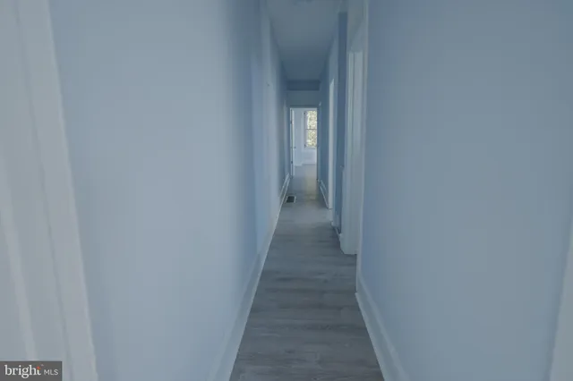 a view of a hallway with a wooden floor