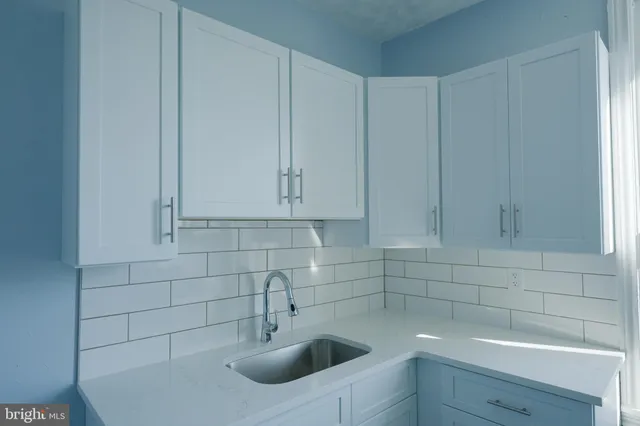 a kitchen with a sink and cabinets