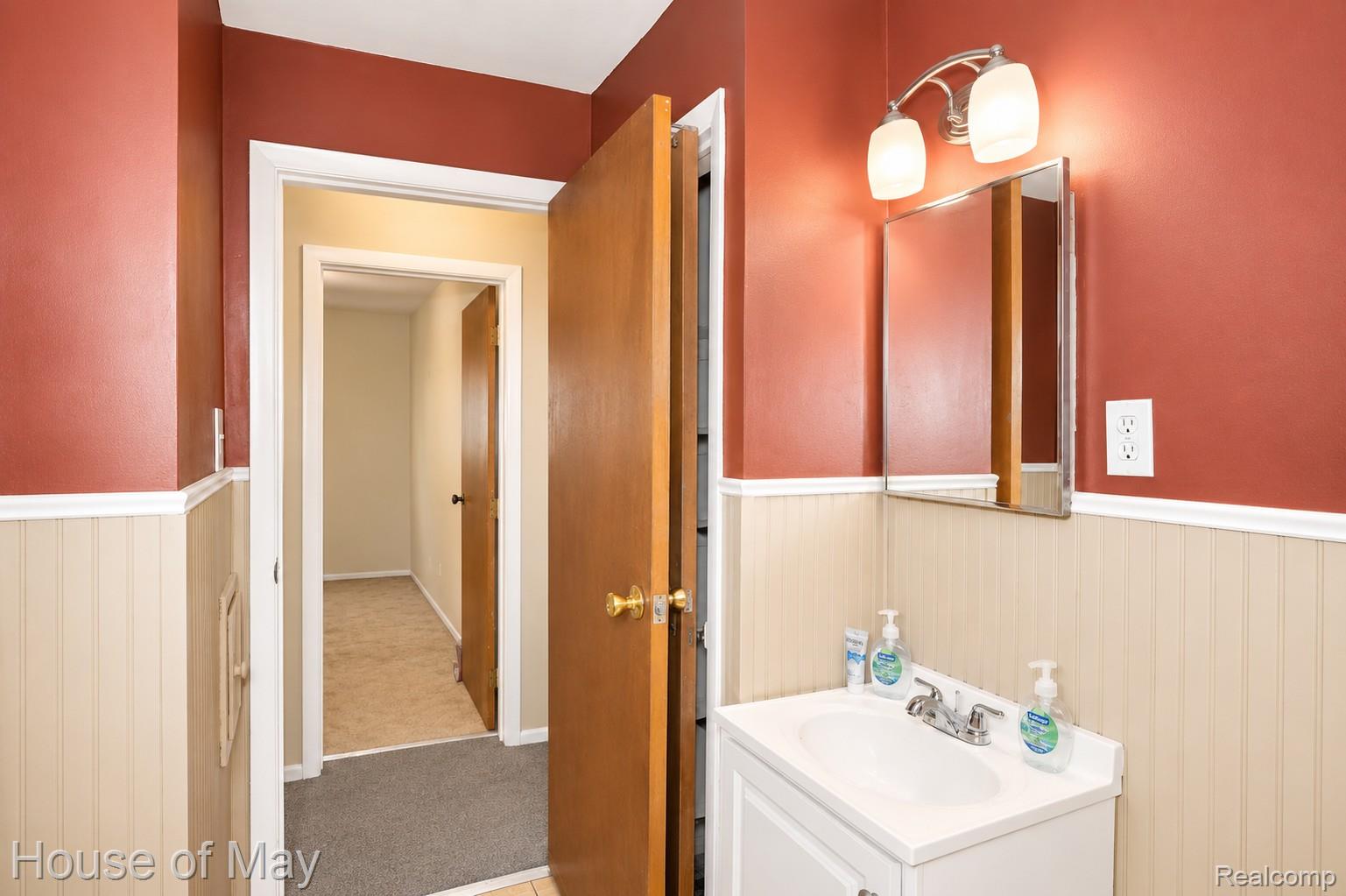 18233 Ruth Street Melvindale, MI 48122 - Photo 8 of 17 Bathroom vanity with an integrated white sink, brushed nickel faucet, and a wall-mounted medicine cabinet