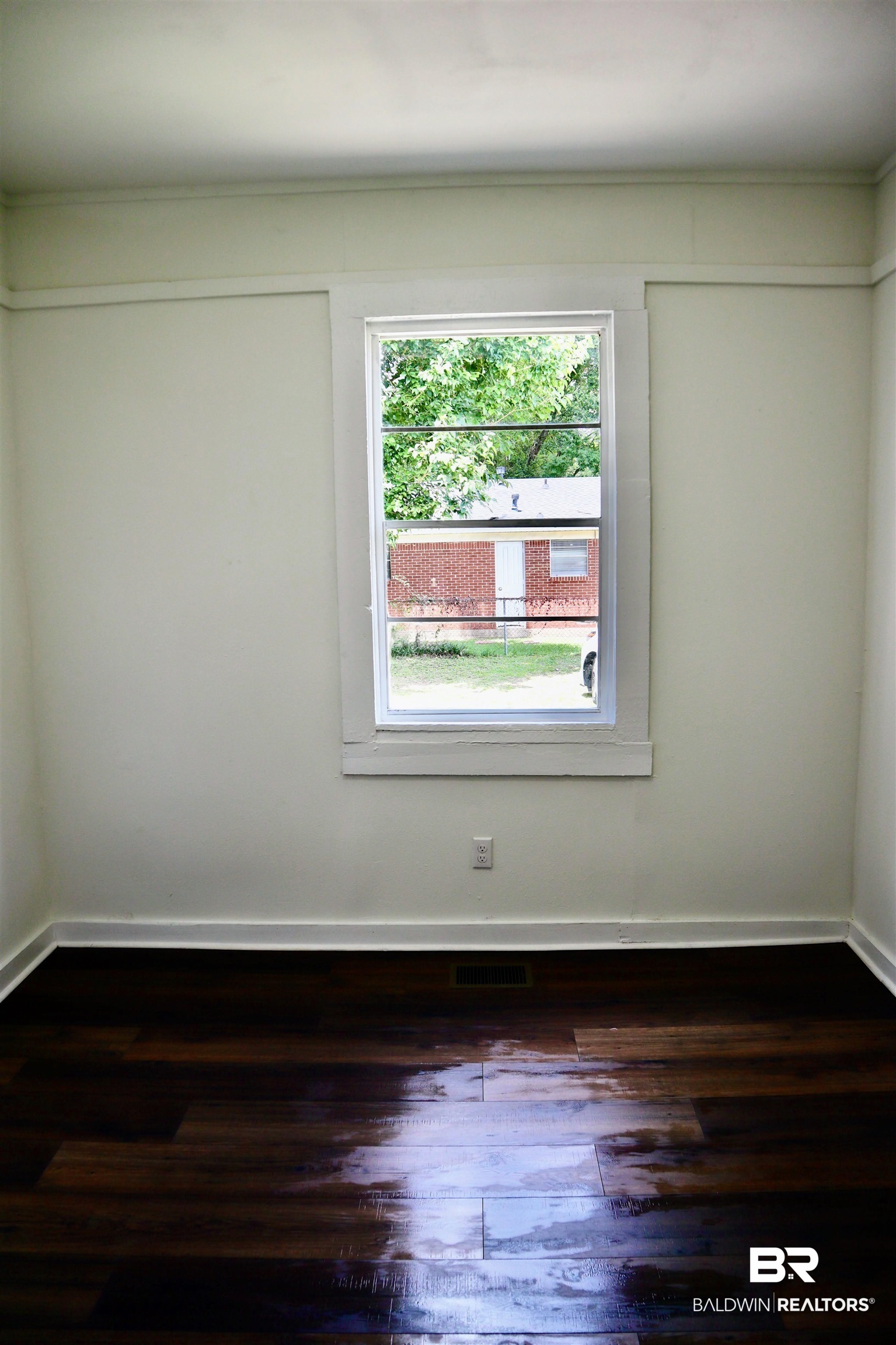 1009 Baltimore Street Mobile, AL 36605 - Photo 11 of 17 Unfurnished room featuring wood finished floors and baseboards