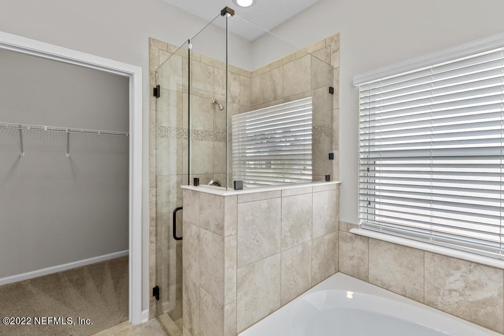 9802 Kevin Road Jacksonville, FL 32257 - Photo 13 of 22 a bathroom with a shower and a window