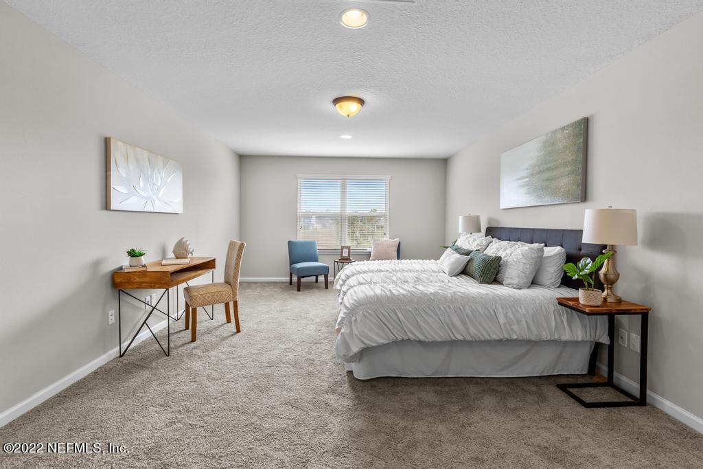 9802 Kevin Road Jacksonville, FL 32257 - Photo 15 of 22 a bedroom with a bed and a couch