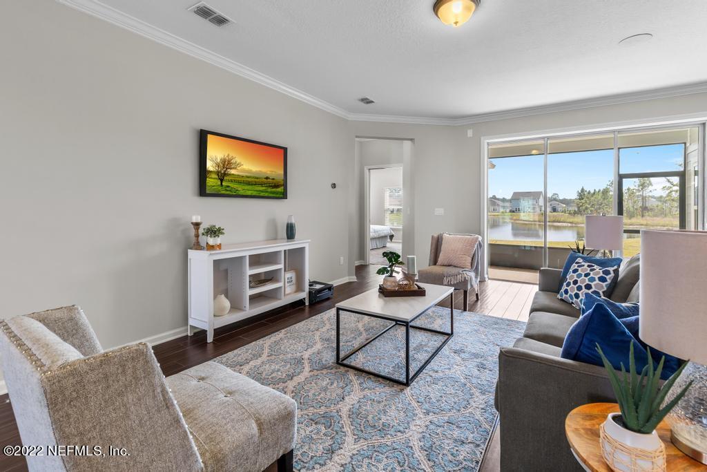 9802 Kevin Road Jacksonville, FL 32257 - Photo 4 of 22 a living room with furniture a rug and a flat screen tv