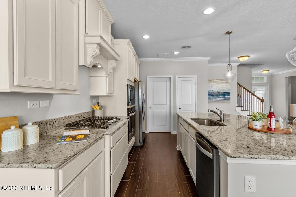 9802 Kevin Road Jacksonville, FL 32257 - Photo 7 of 22 a kitchen with stainless steel appliances granite countertop a sink stove and cabinets