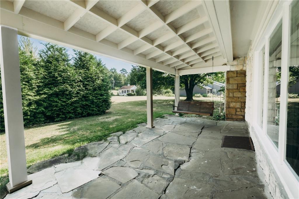 667 East Pike Road Indiana, PA 15701 - Photo 27 of 35 a view of a porch with couches and chairs under an umbrella