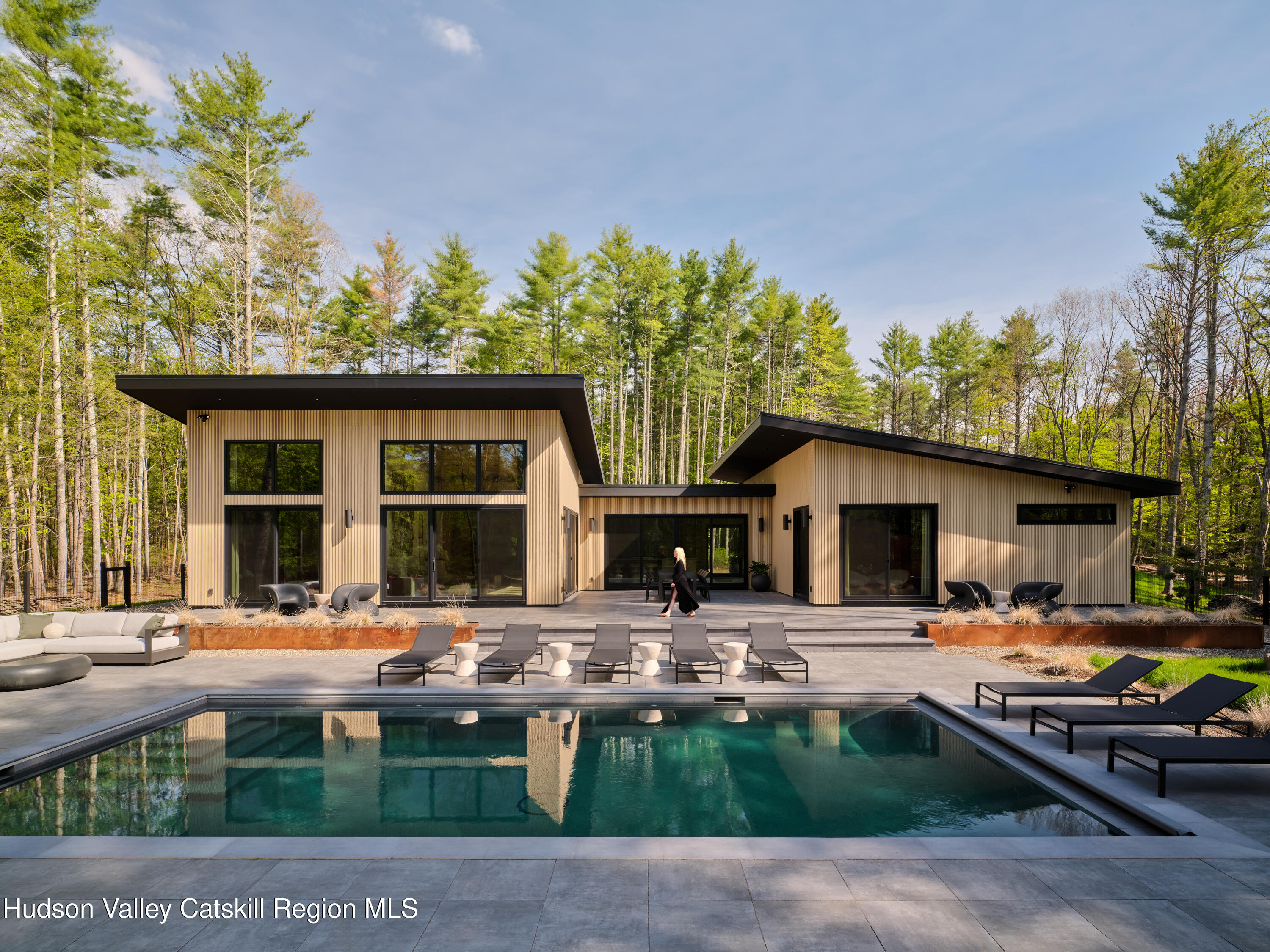 a front view of a house with swimming pool and porch