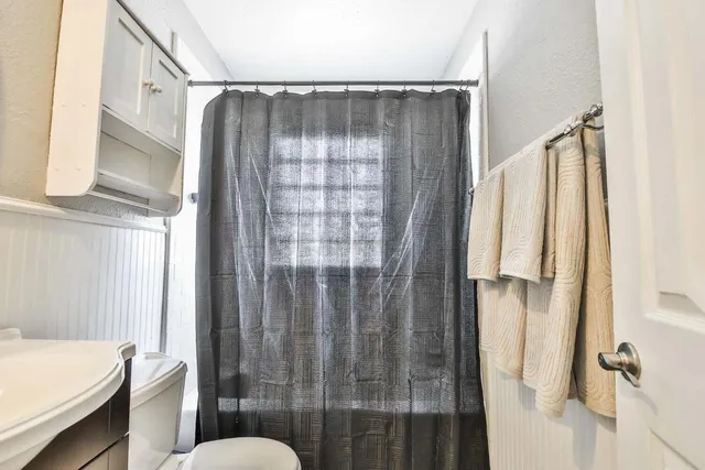 a bathroom with a shower and a toilet