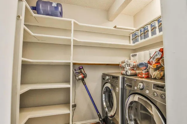 a view of storage and utility room with washer and dryer
