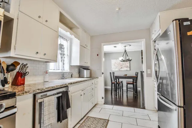 a kitchen with a sink appliances and cabinets