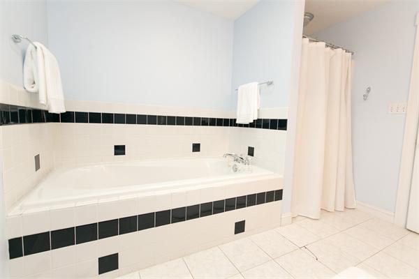 131 Harvard Road Bolton, MA 01740 - Photo 20 of 30 a bathroom with a bathtub and a shower