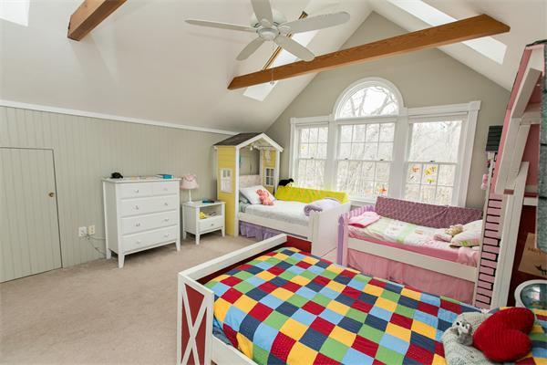 131 Harvard Road Bolton, MA 01740 - Photo 22 of 30 a living room with furniture and a baby crib