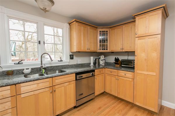 131 Harvard Road Bolton, MA 01740 - Photo 4 of 30 a kitchen with granite countertop stainless steel appliances a sink window and cabinets