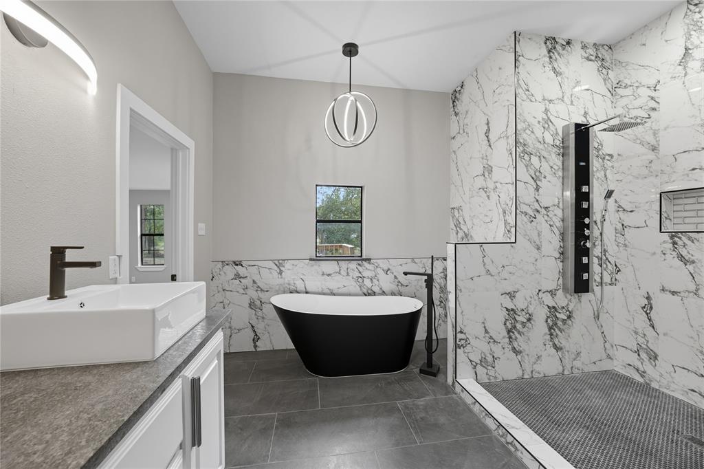 5393 Fm 2892 Athens, TX 75752 - Photo 12 of 25 a spacious bathroom with a bathtub sink and mirror