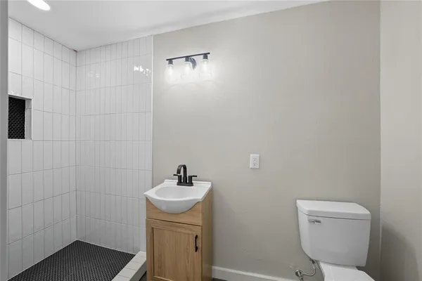 a bathroom with a toilet sink and shower