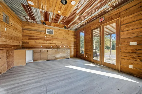 a view of a kitchen with stainless steel appliances granite countertop a stove and wooden floor