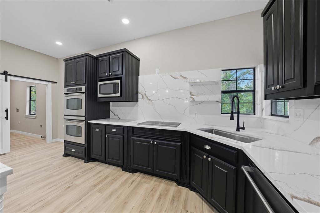 5393 Fm 2892 Athens, TX 75752 - Photo 8 of 25 a kitchen with stainless steel appliances granite countertop wooden cabinets a sink and dishwasher