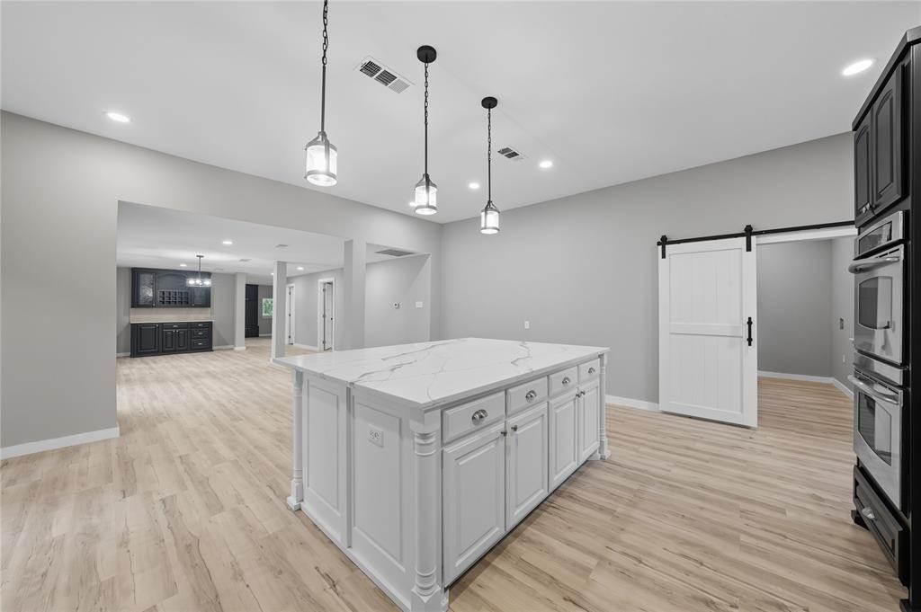 5393 Fm 2892 Athens, TX 75752 - Photo 9 of 25 a kitchen with a stove a refrigerator a center island with wooden floor