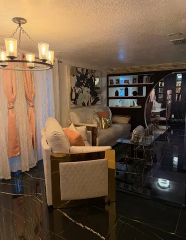 a living room with furniture a lamp and a window