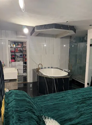 a kitchen with kitchen island a wooden floor and a sink