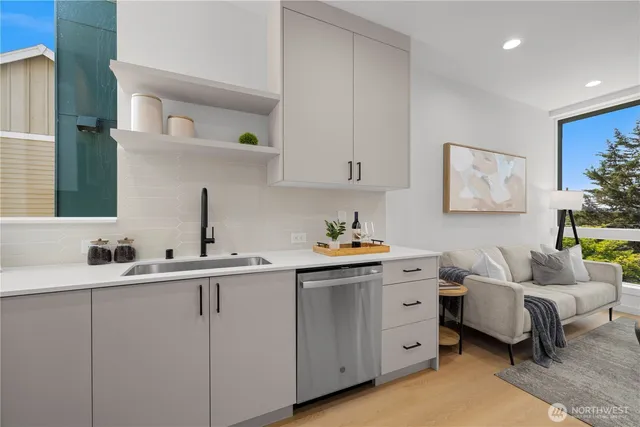 a kitchen with stainless steel appliances a refrigerator a stove a dining table and chairs