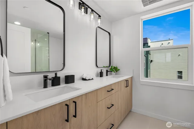a bathroom with a double vanity sink and mirror
