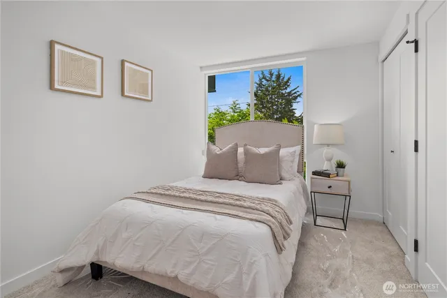 a bedroom with a large bed and hallway