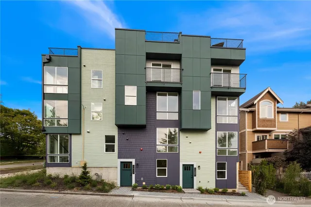 a front view of a residential apartment building with a yard