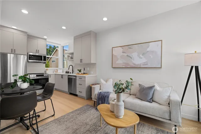 a living room with furniture kitchen and a table