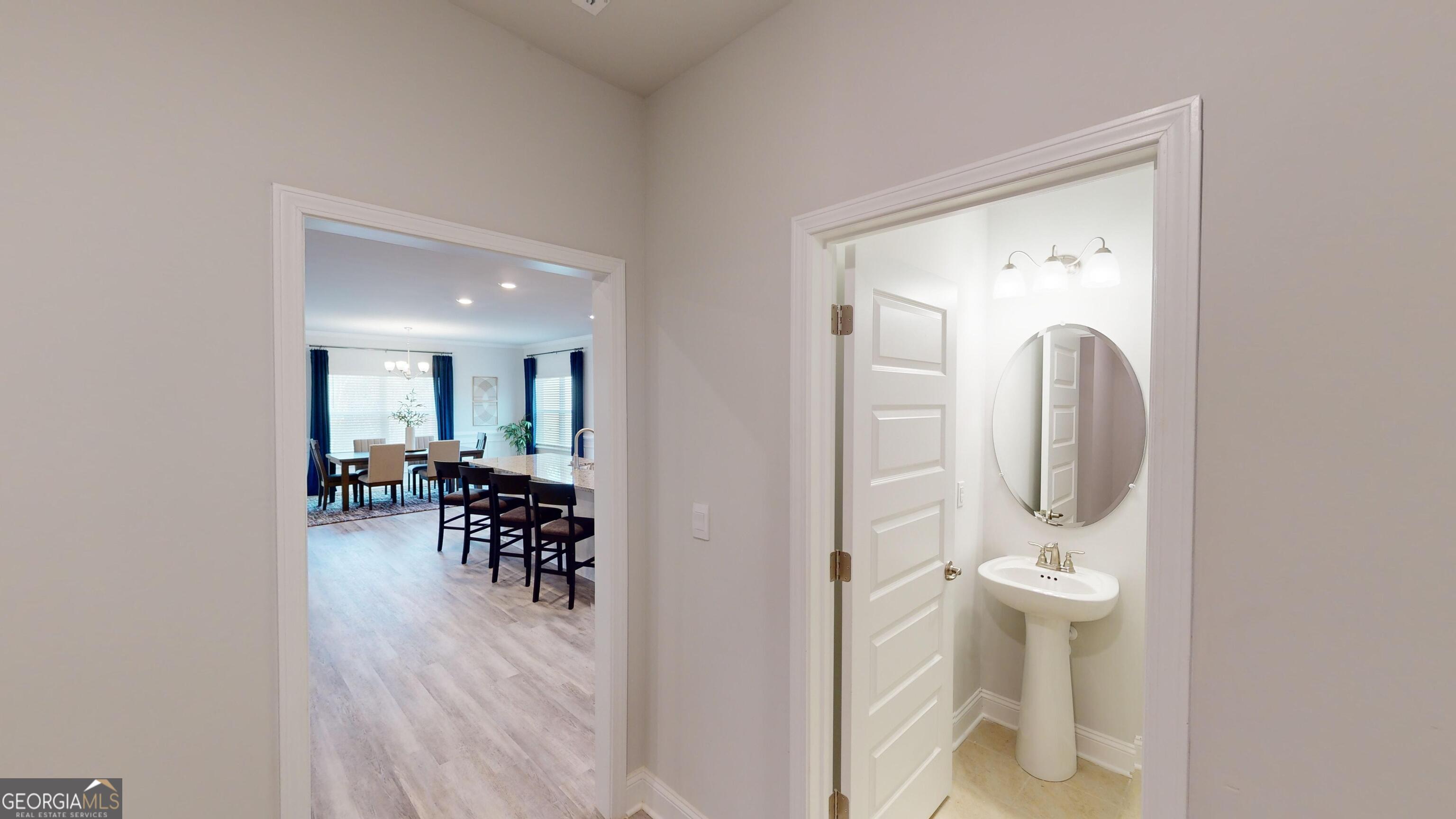 363 Eagle Ridge Road Macon, GA 31216 - Photo 12 of 40 a view of a hallway with wooden floor and a dining room