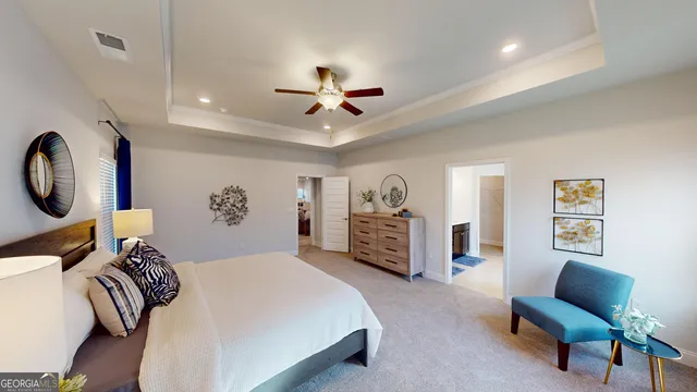 a spacious bedroom with a bed a couch and a chandelier