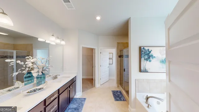 a bathroom with a double vanity sink mirror and shower