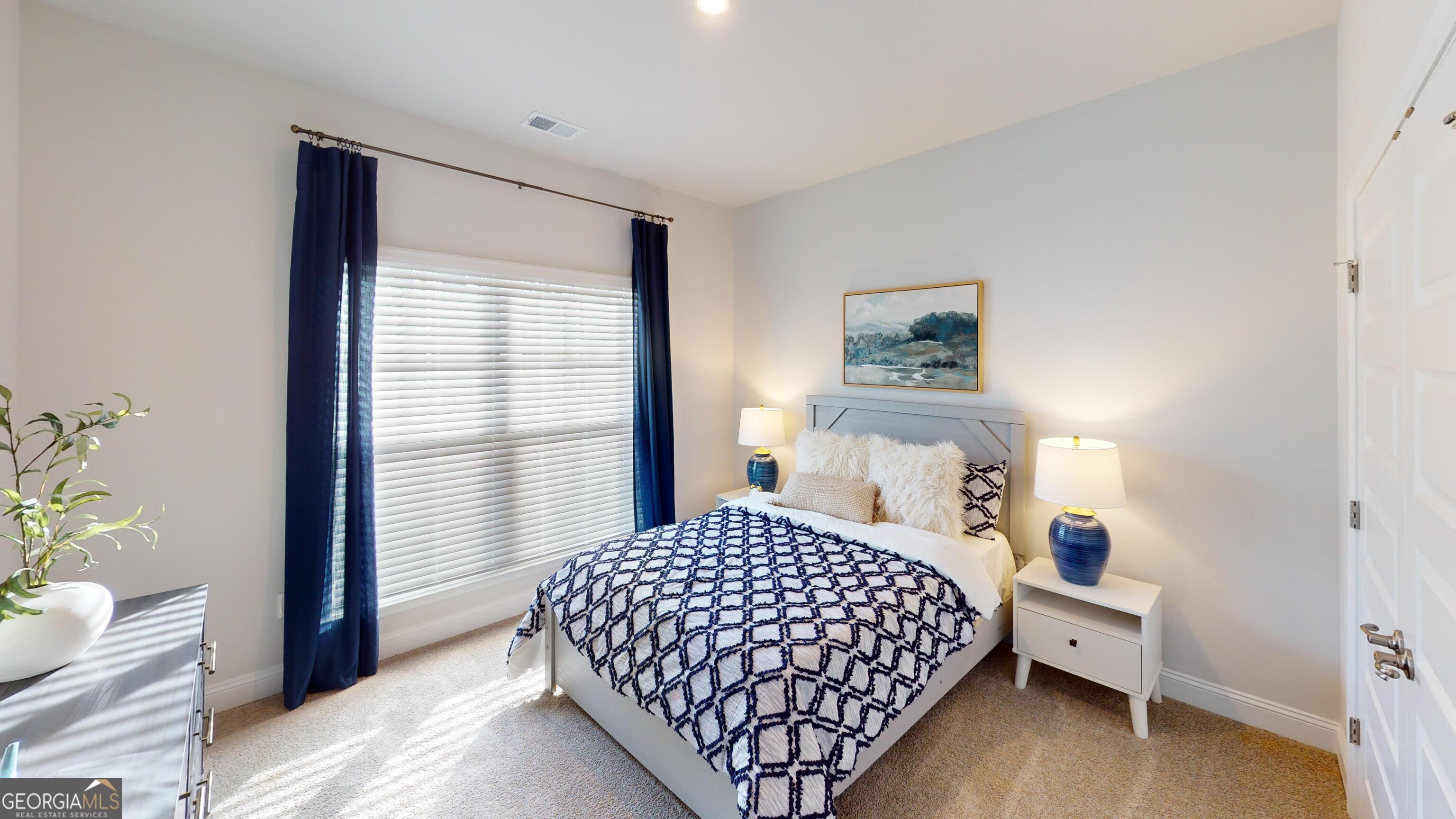 363 Eagle Ridge Road Macon, GA 31216 - Photo 27 of 40 a bedroom with a large bed and a window