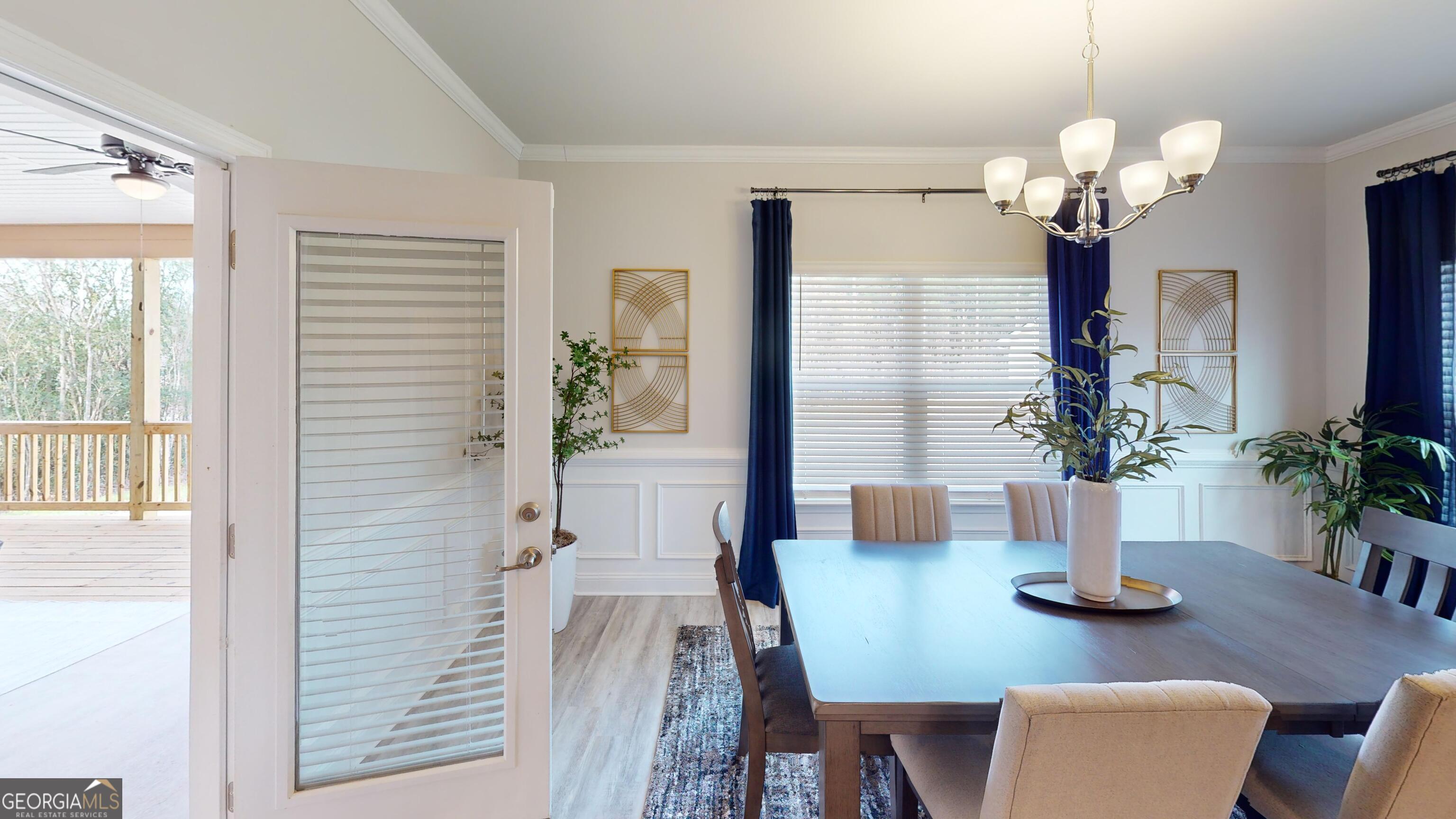 363 Eagle Ridge Road Macon, GA 31216 - Photo 5 of 40 a view of a dining room with furniture a chandelier and large window