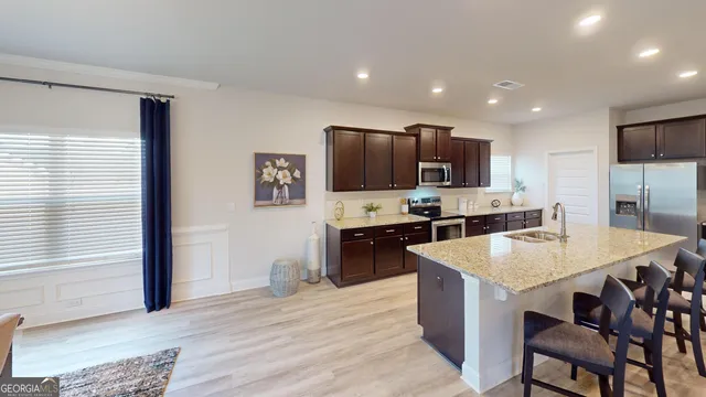 a large kitchen with kitchen island a sink counter space and stainless steel appliances