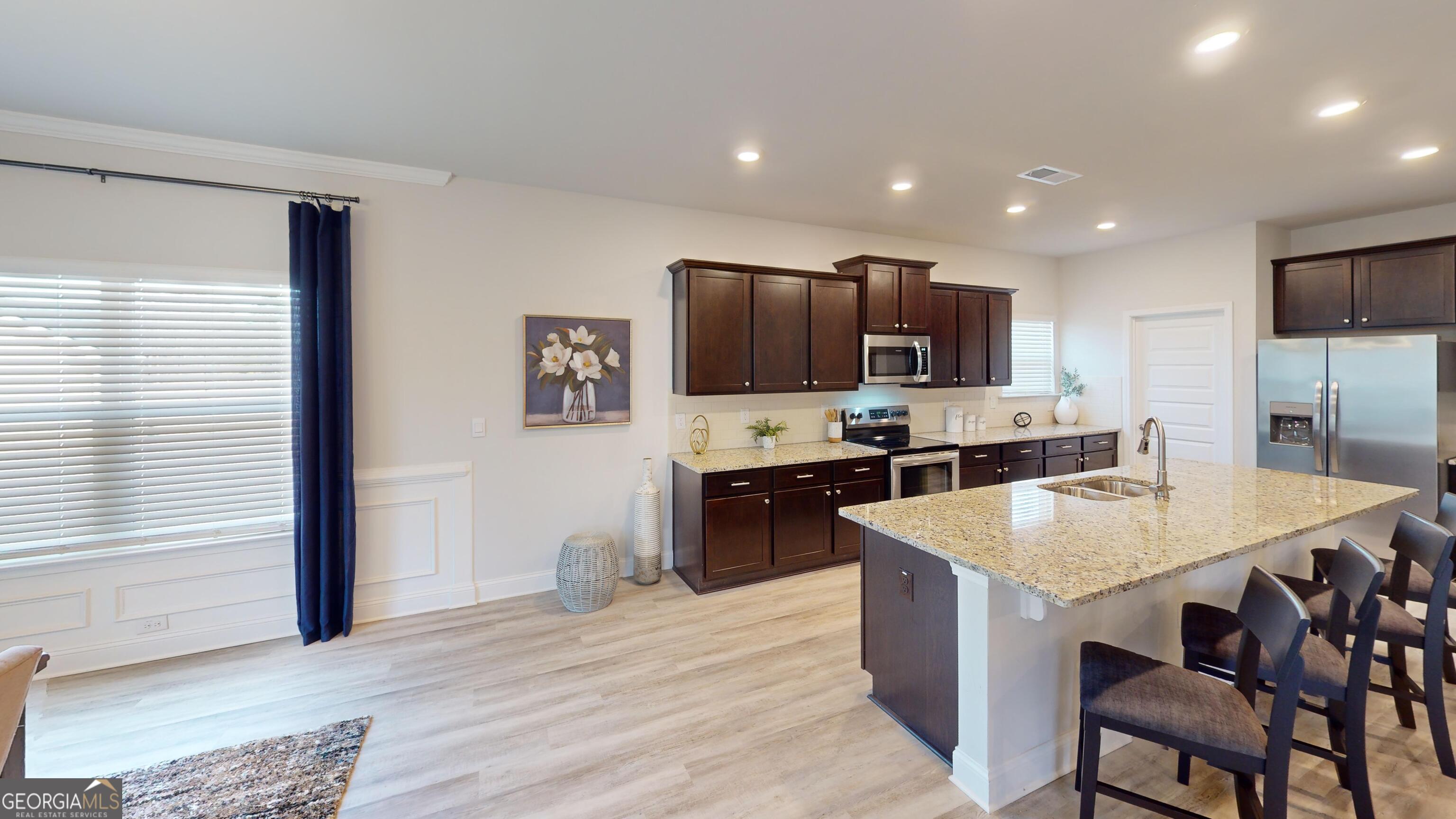 363 Eagle Ridge Road Macon, GA 31216 - Photo 8 of 40 a large kitchen with kitchen island a sink counter space and stainless steel appliances