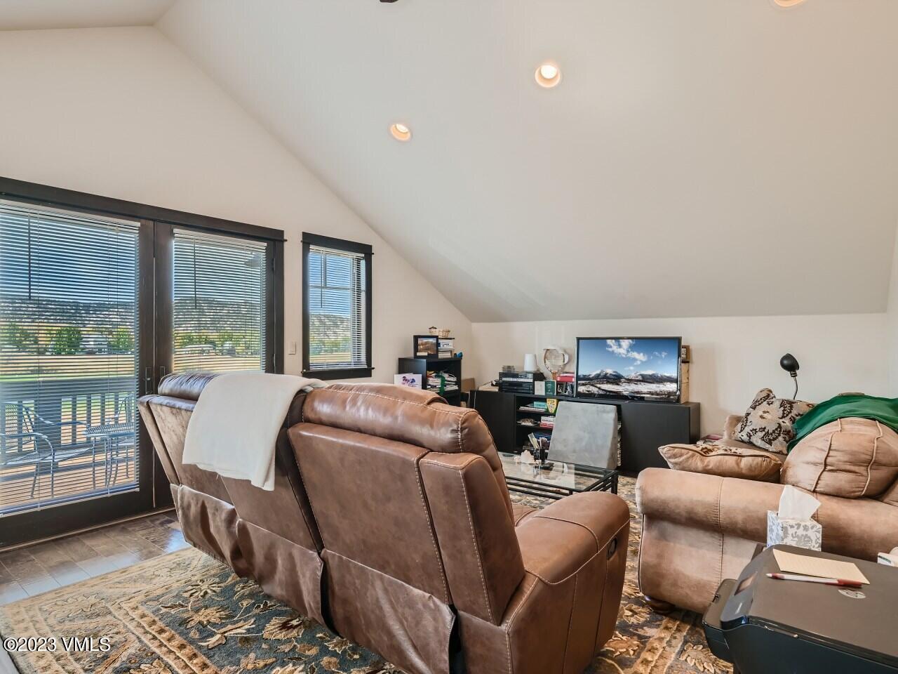 67 Robins Egg Eagle, CO 81631 - Photo 20 of 38 a living room with furniture a fireplace and a floor to ceiling window