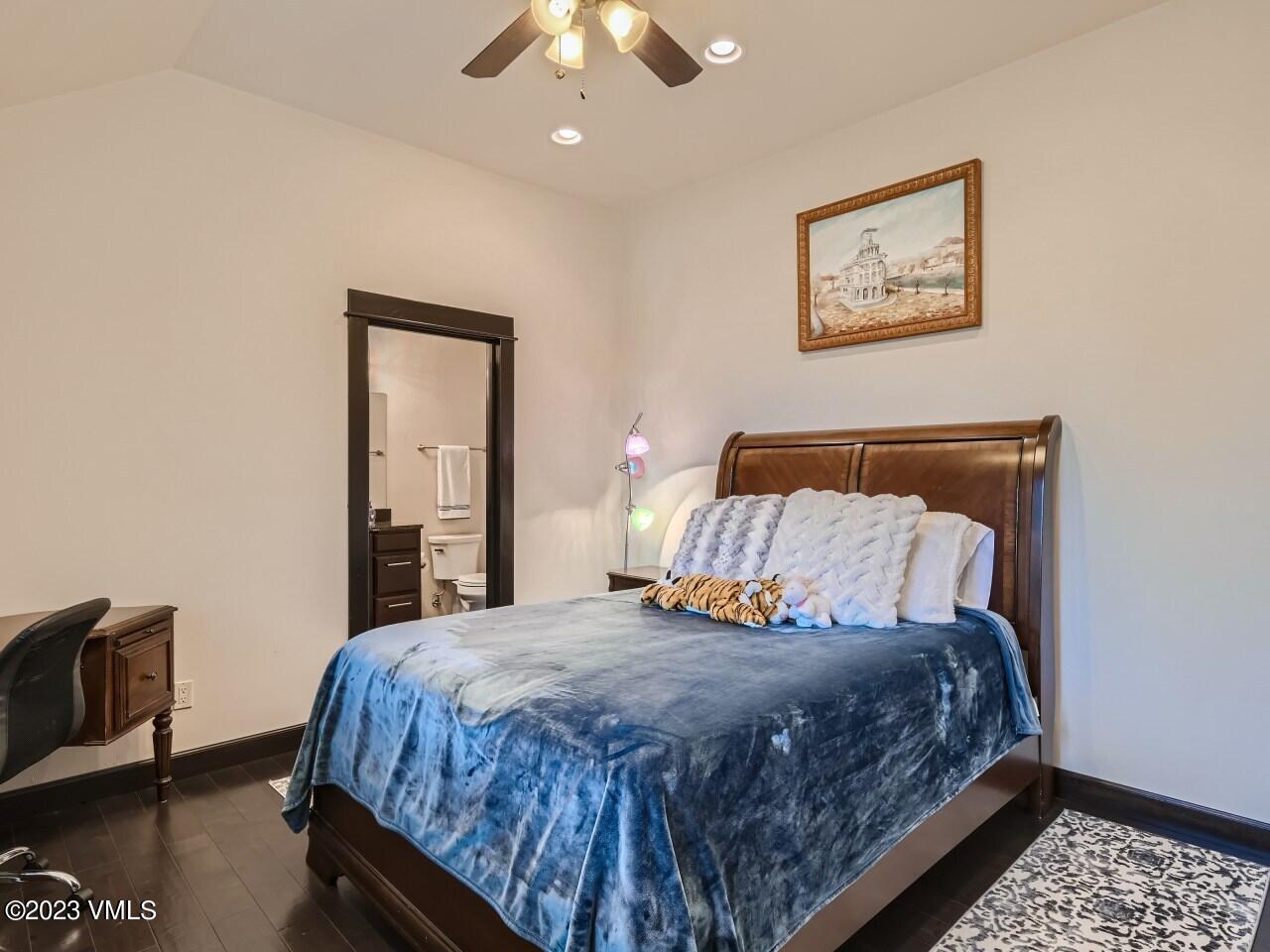 67 Robins Egg Eagle, CO 81631 - Photo 23 of 38 a bedroom with a large bed and a chandelier