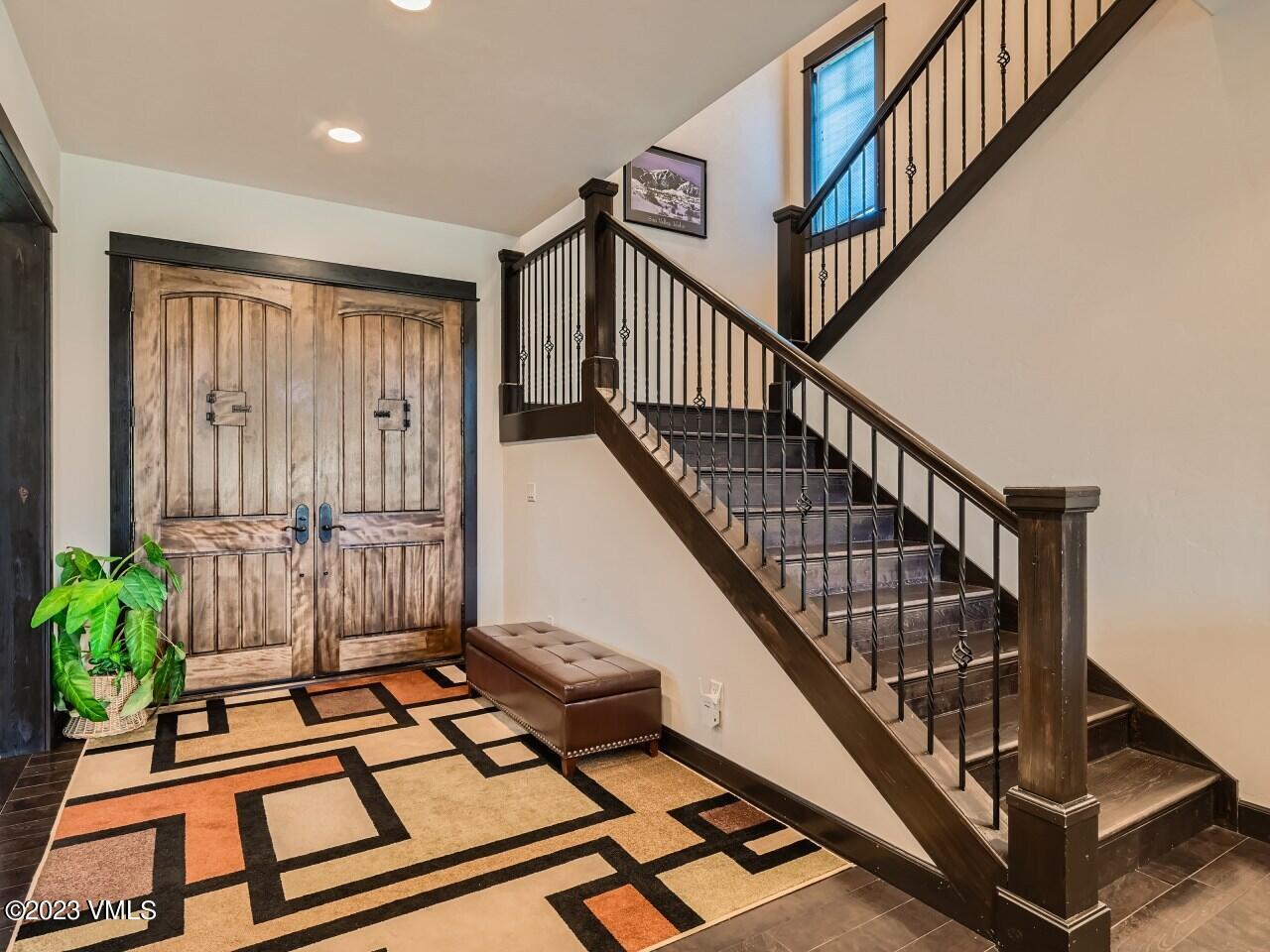 67 Robins Egg Eagle, CO 81631 - Photo 5 of 38 a view of staircase with wooden floor and a rug