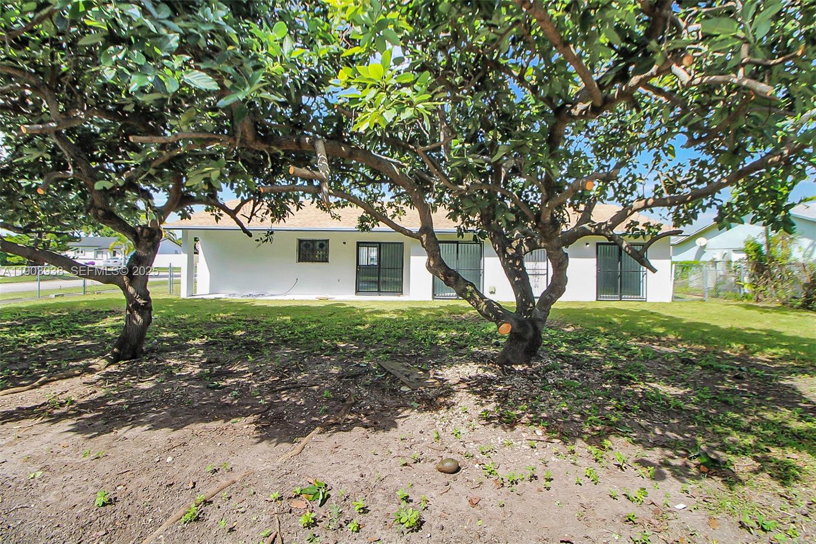 13224 Southwest 253rd Terrace Homestead, FL 33032 - Photo 16 of 19 a front view of a house with a yard