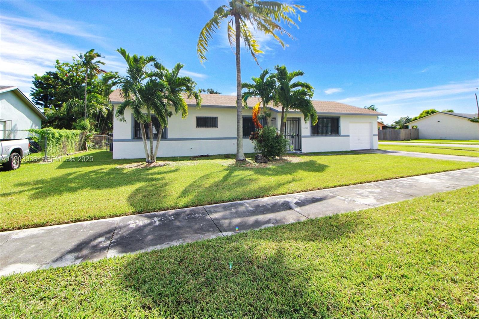 13224 Southwest 253rd Terrace Homestead, FL 33032 - Photo 19 of 19 a view of a house with a yard and palm trees