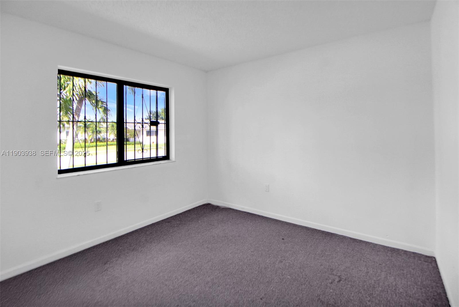 13224 Southwest 253rd Terrace Homestead, FL 33032 - Photo 6 of 19 a view of an empty room with a window